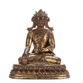 A GILT BRONZE 'CROWNED SHAKYAMUNI' FIGURE