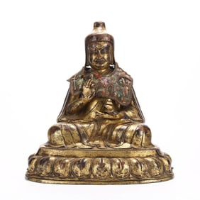 A GILT BRONZE 'LAMA' FIGURE