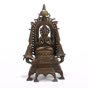 AN ALLOY COPPER 'FOUR-ARMED GUANYIN' FIGURE