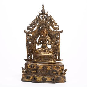 A GILT BRONZE 'FOUR-ARMED GUANYIN' FIGURE