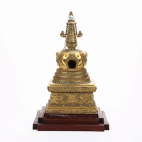 A GILT BRONZE STUPA