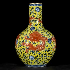 A BLUE AND WHITE CARVED WITH IRON-RED AND GILT 'FIVE DRAGONS' GLOBULAR VASE
