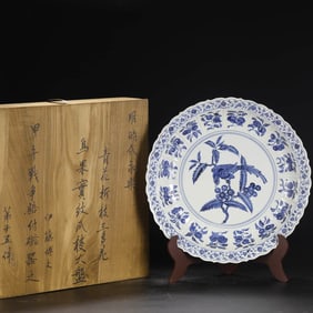 A BLUE AND WHITE 'FLOWERS, BIRDS AND FRUITS' MELON-RIBBED DISH