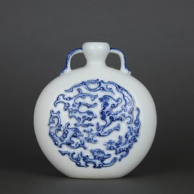 A WHITE-GLAZED BLUE AND WHITE CARVED 'CHI DRAGON' MOONFLASK