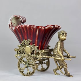 A RED-GLAZED 'MONKEY-PULLED CART' FRUIT BASKET