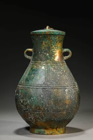 A GILT-BRONZE COVERED VASE