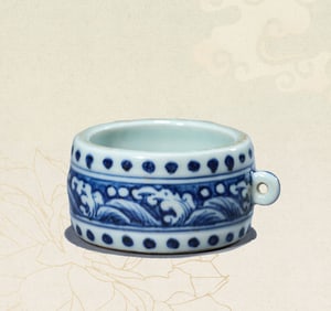 A BLUE AND WHITE BIRD FEEDER