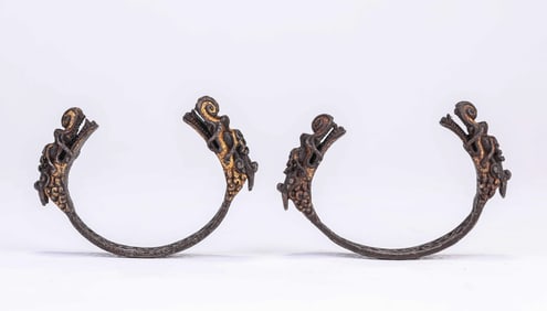 A PAIR OF TIBETAN IRON AND GOLD-INLAID OPENWORK 'DRAGON HEAD' BRACELETS