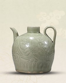 A YAOZHOU CARVED 'PHOENIX AMONG FLOWERS' EWER