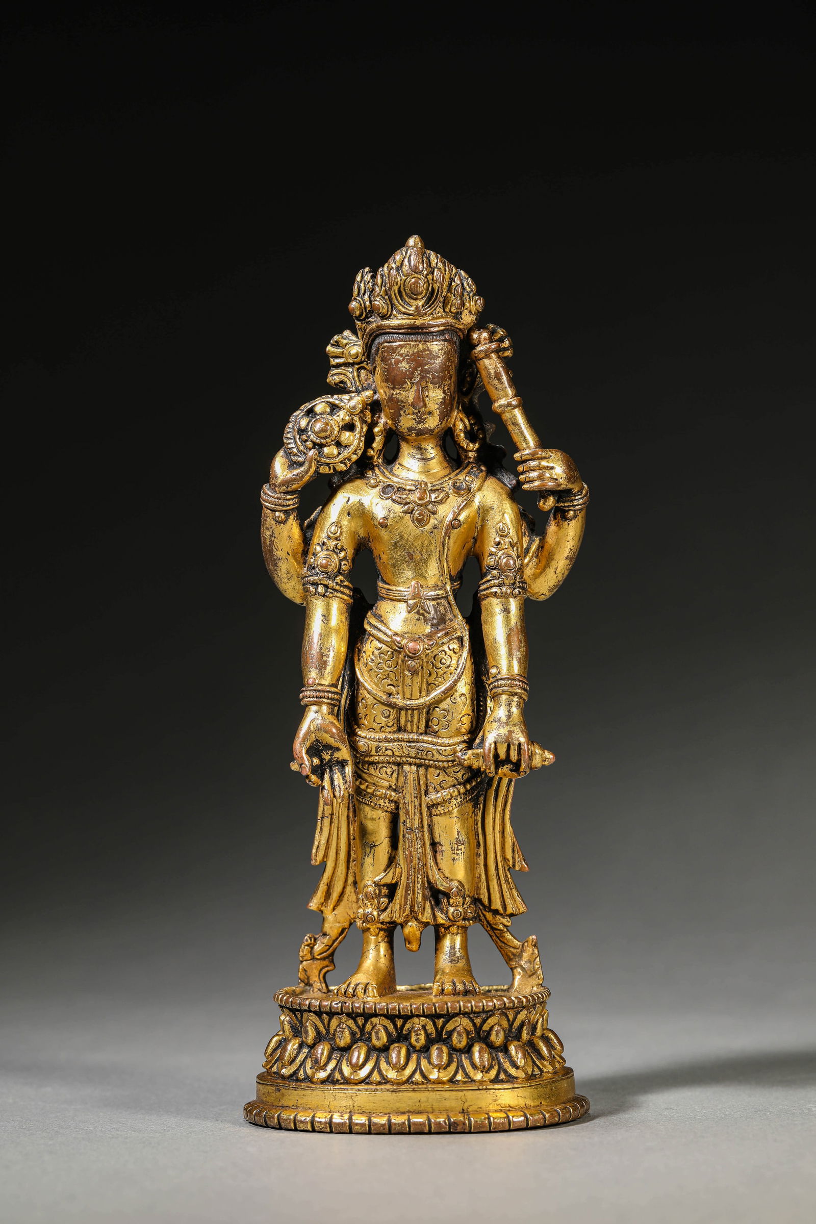 A GILT-BRONZE FOUR-ARMED AVALOKITESHVARA: A GILT-BRONZE FOUR-ARMED AVALOKITESHVARA Dimensions:Weight: 678g. Length: 7.3cm (2.87in) x Width: 5.3cm (2.09in) x Height: 18.5cm (7.28in). All measurements are approximate. Azaya Art Gallery is delig