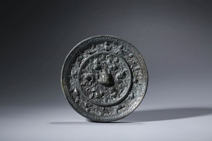 A BRONZE 'SEA BEASTS AND GRAPES' MIRROR