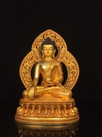 A NEPALESE GILT-COPPER HALOED SHAKYAMUNI STATUE