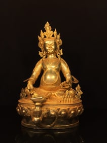 A GILT-COPPER JAMBALA STATUE