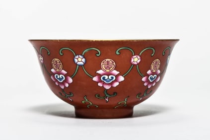 A RUBY RED-GROUND 'BEAST' BOWL