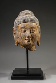 A LACQUERED STONE BUDDHA HEAD