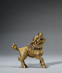 A GILT-BRONZE QILIN ORNAMENT