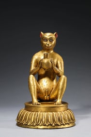 A GILT-BRONZE MONKEY