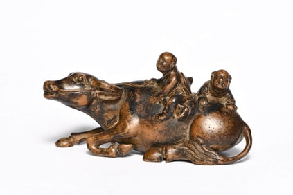 A BRONZE 'BUFFALO-RIDING SHEPHERD' ORNAMENT