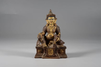 A LACQUERED AND GILDED BRONZE FIGURE OF THE YELLOW JAMBHALA