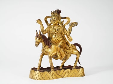 A GILT-BRONZE FIGURE OF THE EIGHT-HORSE GOD OF WEALTH