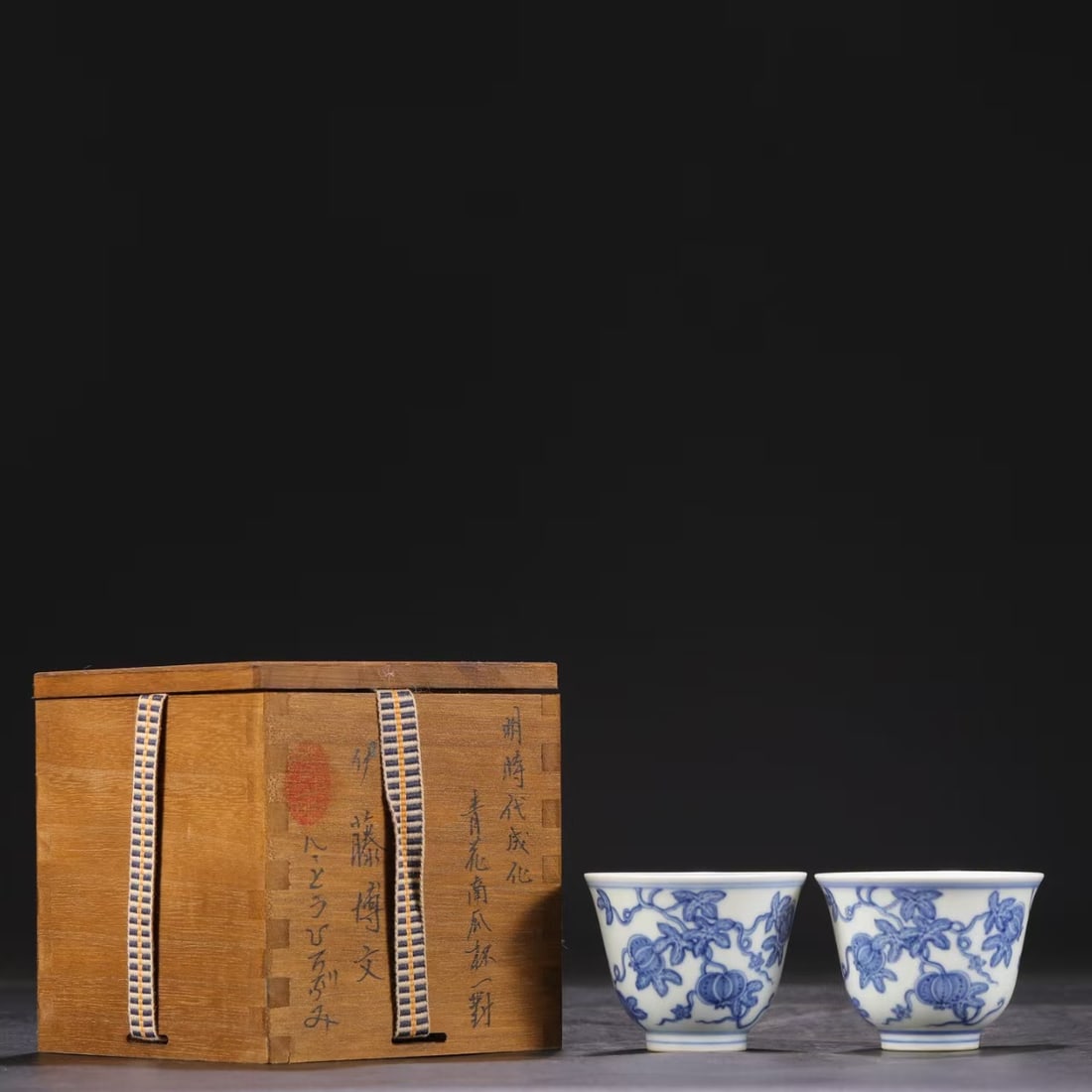 A PAIR OF BLUE AND WHITE 'PUMPKIN' BELL-SHAPED CUPS: A PAIR OF BLUE AND WHITE 'PUMPKIN' BELL-SHAPED CUPS Dimensions: Length: 5.5 cm (2.2 in.), Width: 7 cm (2.8 in.). All measurements are approximate.