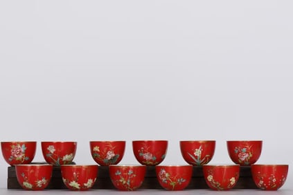 AN ENAMEL PEPPER-RED WITH GILT 'FLOWER MONTH' CUP