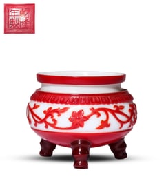 A RED-OVER-WHITE GLASS CENSER WITH THREE FEET