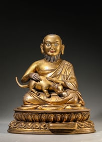 A GILT-BRONZE FIGURE OF WEALTH DEITY