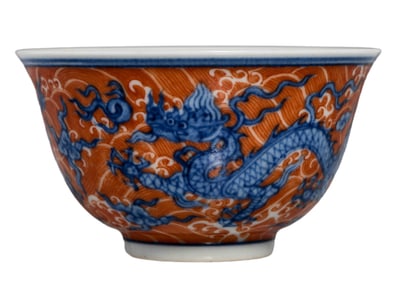 A BLUE AND WHITE WITH IRON-RED 'DRAGON IN WAVES' CUP