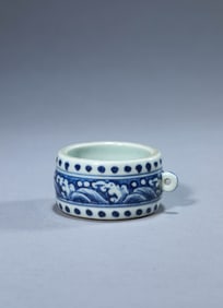 A BLUE AND WHITE BIRD-FEED JAR