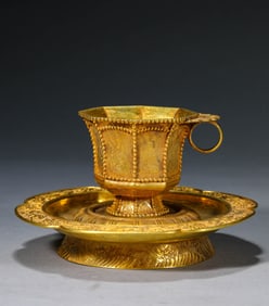 A GILT-SILVER CUP AND SAUCER