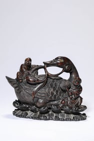 A WOODEN 'CHILD PLAYING WITH GOOSE'