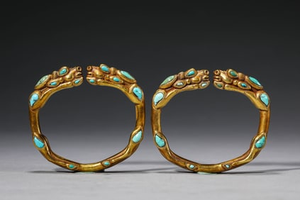 A PAIR OF GILT-SILVER GEM-INLAID BRACELETS