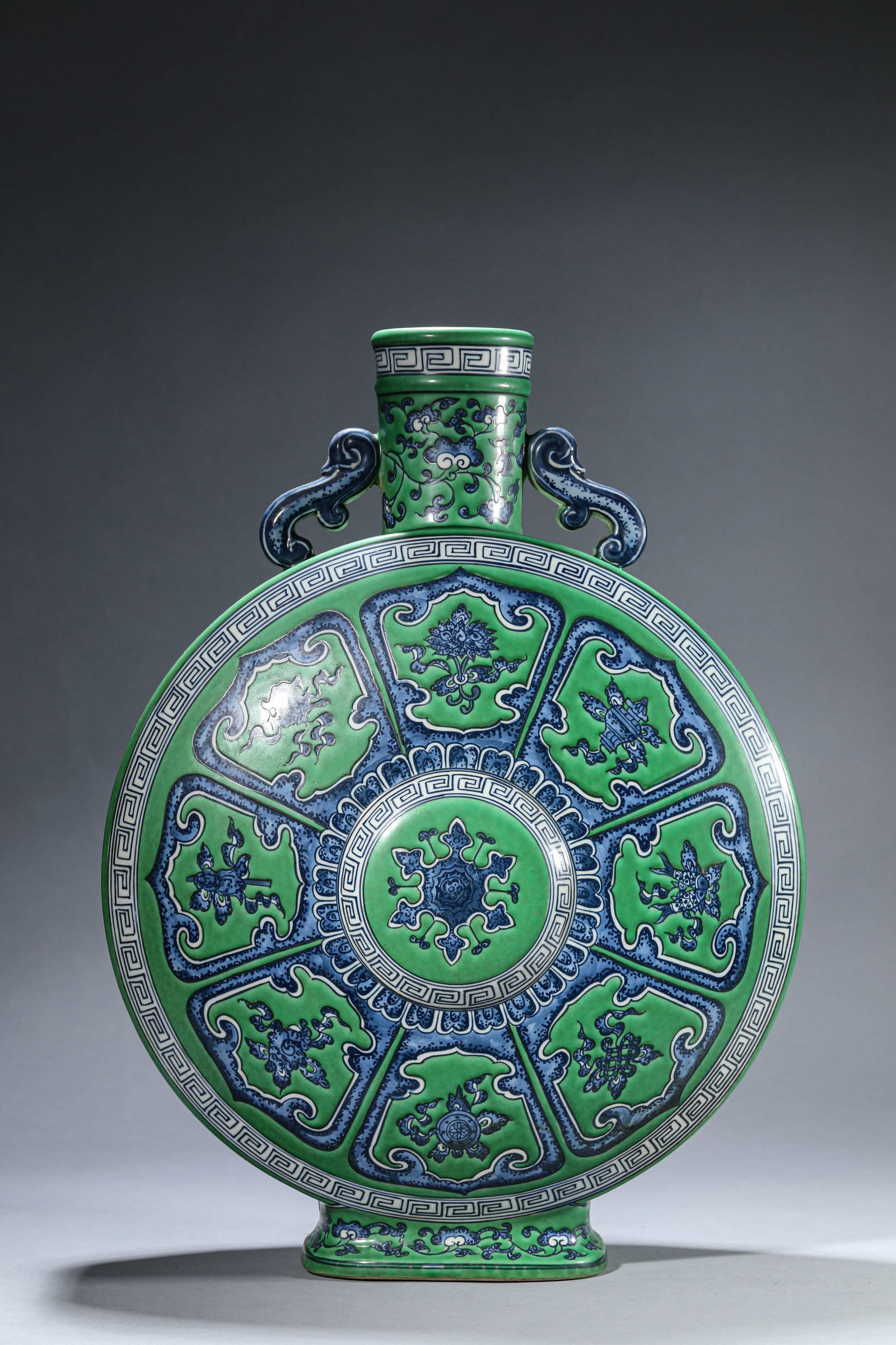 A GREEN-GROUND BLUE AND WHITE 'EIGHT TREASURES' MOONFLASK: A GREEN-GROUND BLUE AND WHITE 'EIGHT TREASURES' MOONFLASK Dimensions: Length: 36.7 cm (14.45 in) x Width: 20.6 cm (8.11 in) x Height: 49.5 cm (19.49 in). All measurements are approximate.