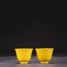 A PAIR OF YELLOW-GLAZED BELL-SHAPED CUPS