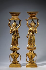 A GILT BRONZE TWO FACED EIGHT ARMED AVALOKITESHVARA CANDLESTICK
