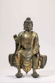 A GILT-BRONZE SEATED FIGURE OF AVALOKITESHVARA