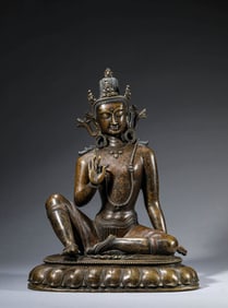 A TIBETAN PALA-STYLE SILVER-AND-COPPER-INLAID ALLOY COPPER FIGURE OF RELAXED AVALOKITESHVARA