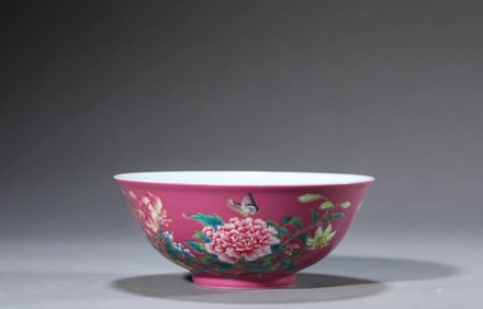 A RUBY RED GROUND FAMILLE-ROSE 'BUTTERFLY-AND-FLOWER' BOWL