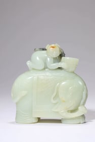A JADE 'CHILD PLAYING WITH ELEPHANT' CARVING