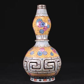 A GILT CLOISONNé ENAMEL PERFORATED 'FLORAL' RUYI-FORM REVOLVING VASE