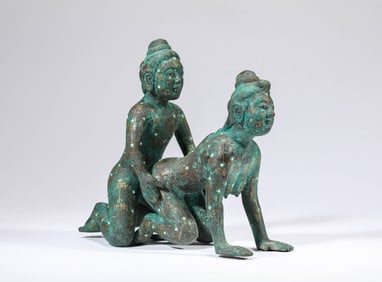 A GOLD-AND-SILVER INLAID BRONZE FIGURE