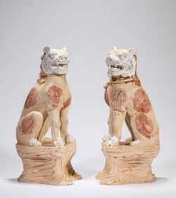 A PAIR OF POTTERY LIONS