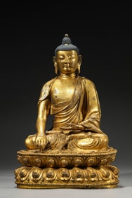 A GILT-BRONZE FIGURE OF SHAKYAMUNI