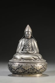 A SILVER FIGURE OF MASTER