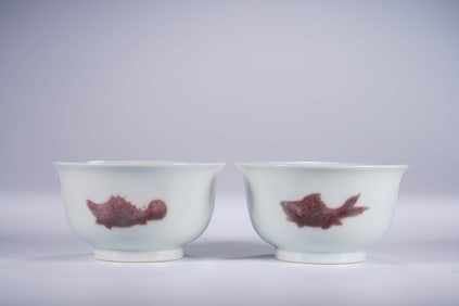A PAIR OF UNDERGLAZED RED 'THREE FISH' CUPS