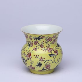 A YELLOW-GROUND FAMILLE ROSE 'MAGPIE ON PLUM BRANCH' SPITTOON