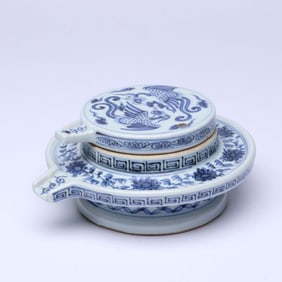 A BLUE AND WHITE 'CLOUD AND PHOENIX' MILLSTONE