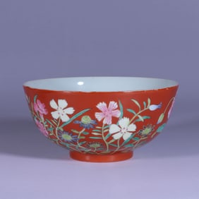 AN IRON-RED GROUND FAMILLE ROSE 'FLORAL' BOWL