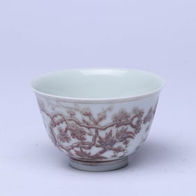 A UNDERGLAZED RED 'PINE, BAMBOO AND PRUNUS' CUP